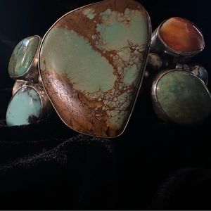 Native American Cuff signed by the maker. Turquoise and coral are the stones.